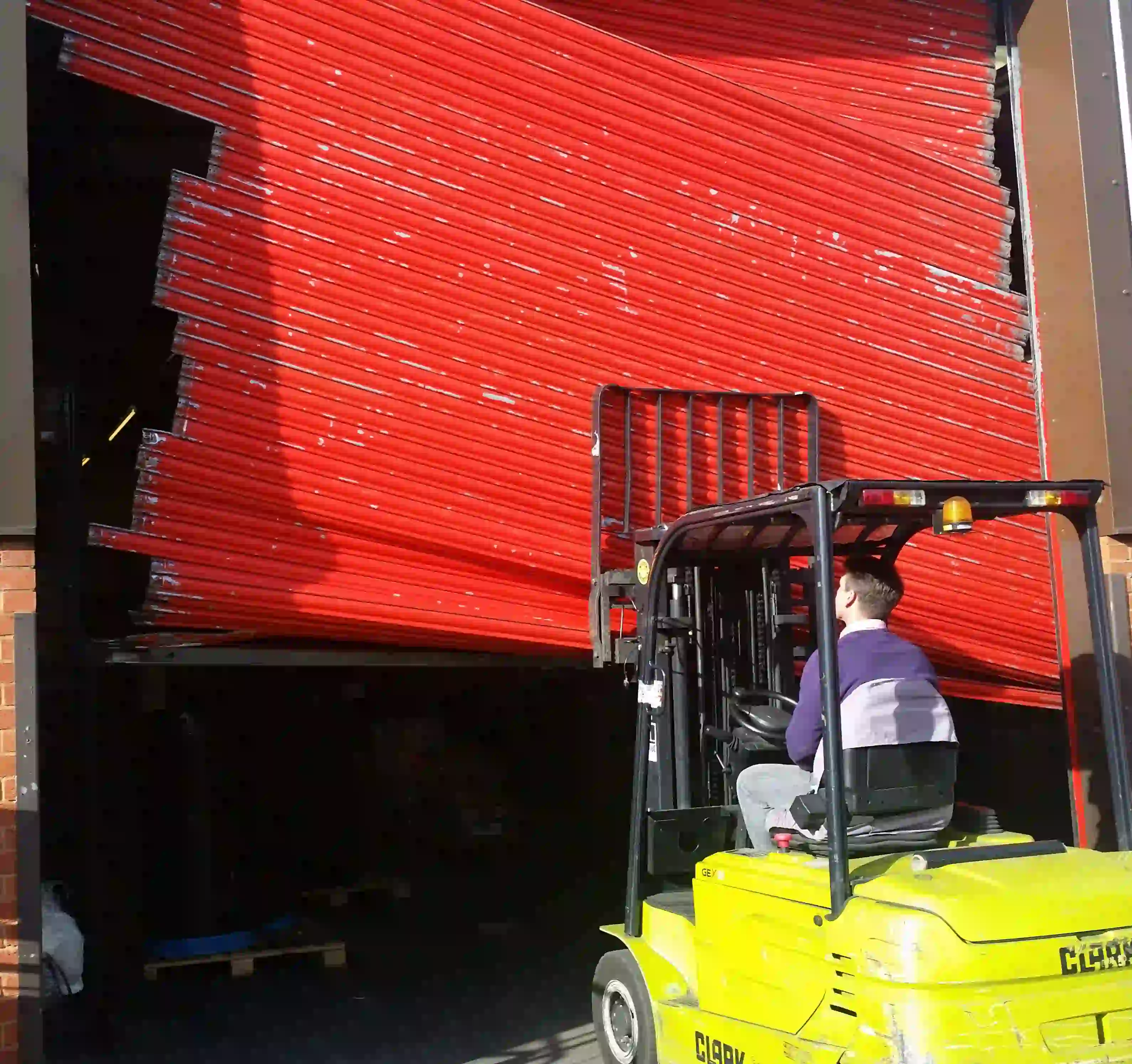 Professional engineer conducting an emergency roller shutter repair on a commercial property in Heathrow.